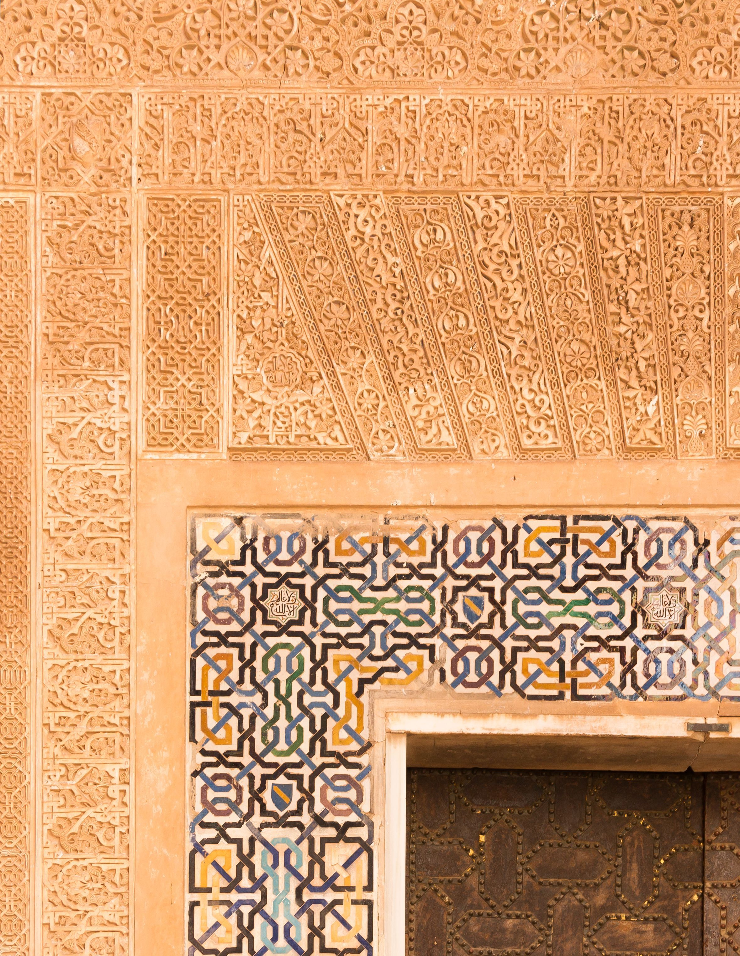 Geometric tilework in the Alhambra, Granada — interlocking star patterns built from octagonal symmetry